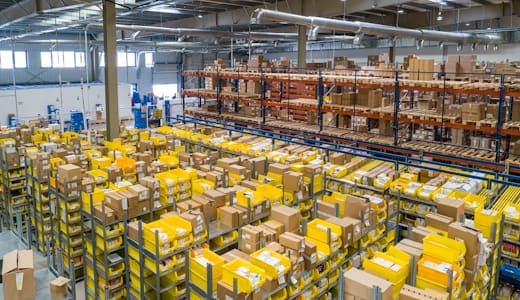 Fulfillment centre floor with sorted bins and cartons ready for shipment
