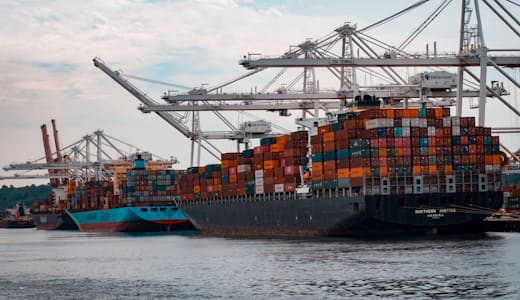 Container ships loading freight at a commercial port terminal